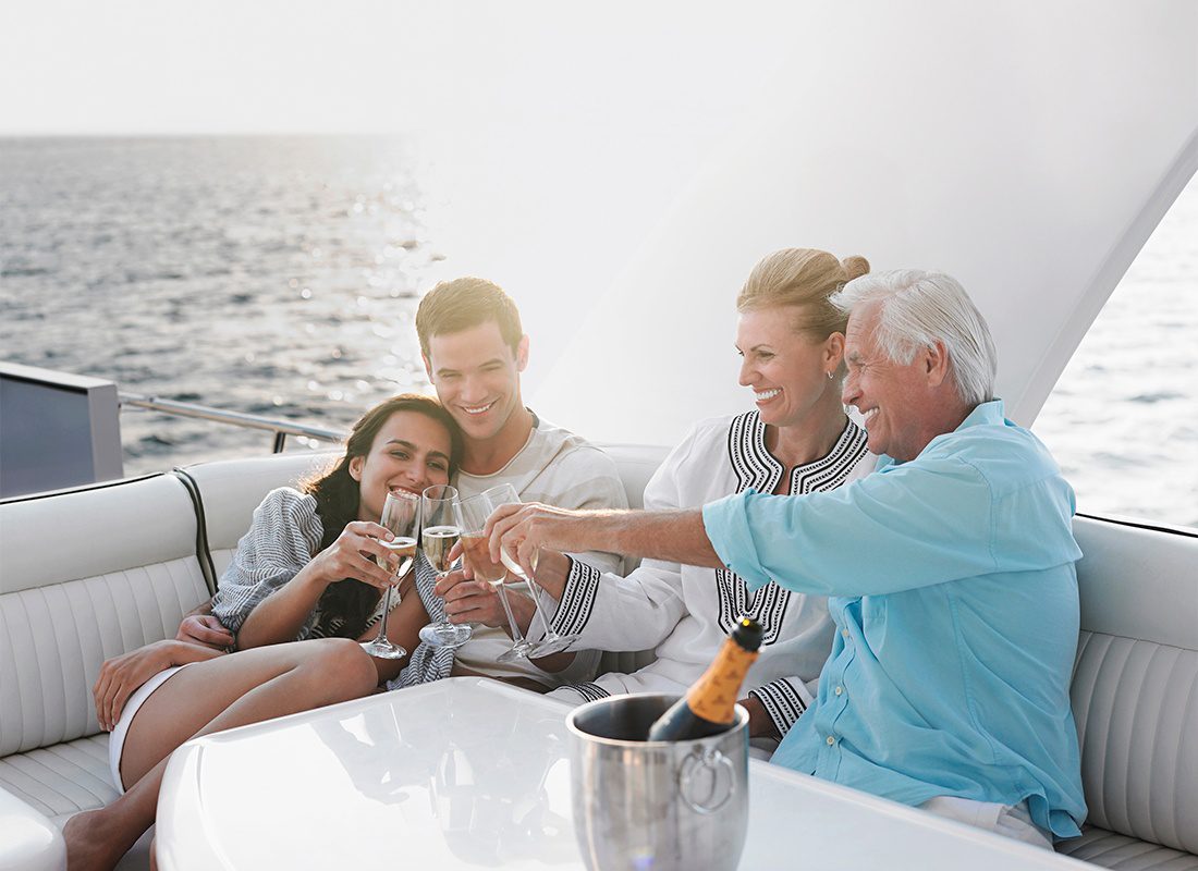 Personal Insurance - A Two Generational Family Celebrating With Champagne on a Yacht